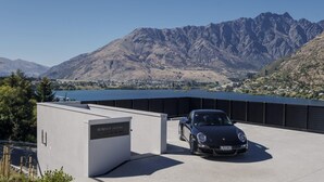 A parking area with a Porsche parked in front of a building labeled "BUNNIE HOUSE."