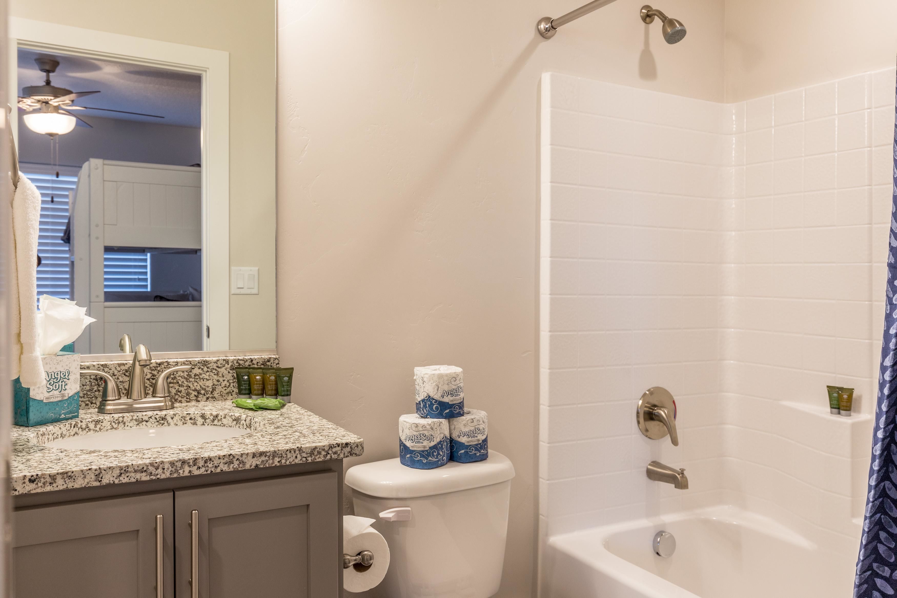 A bathroom with a toilet, sink, and shower.