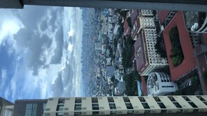 A high-rise building with a modern architectural design, featuring a series of balconies and large windows. - 8Adriatico2 Contemporary Luxurious Studio (Manila)