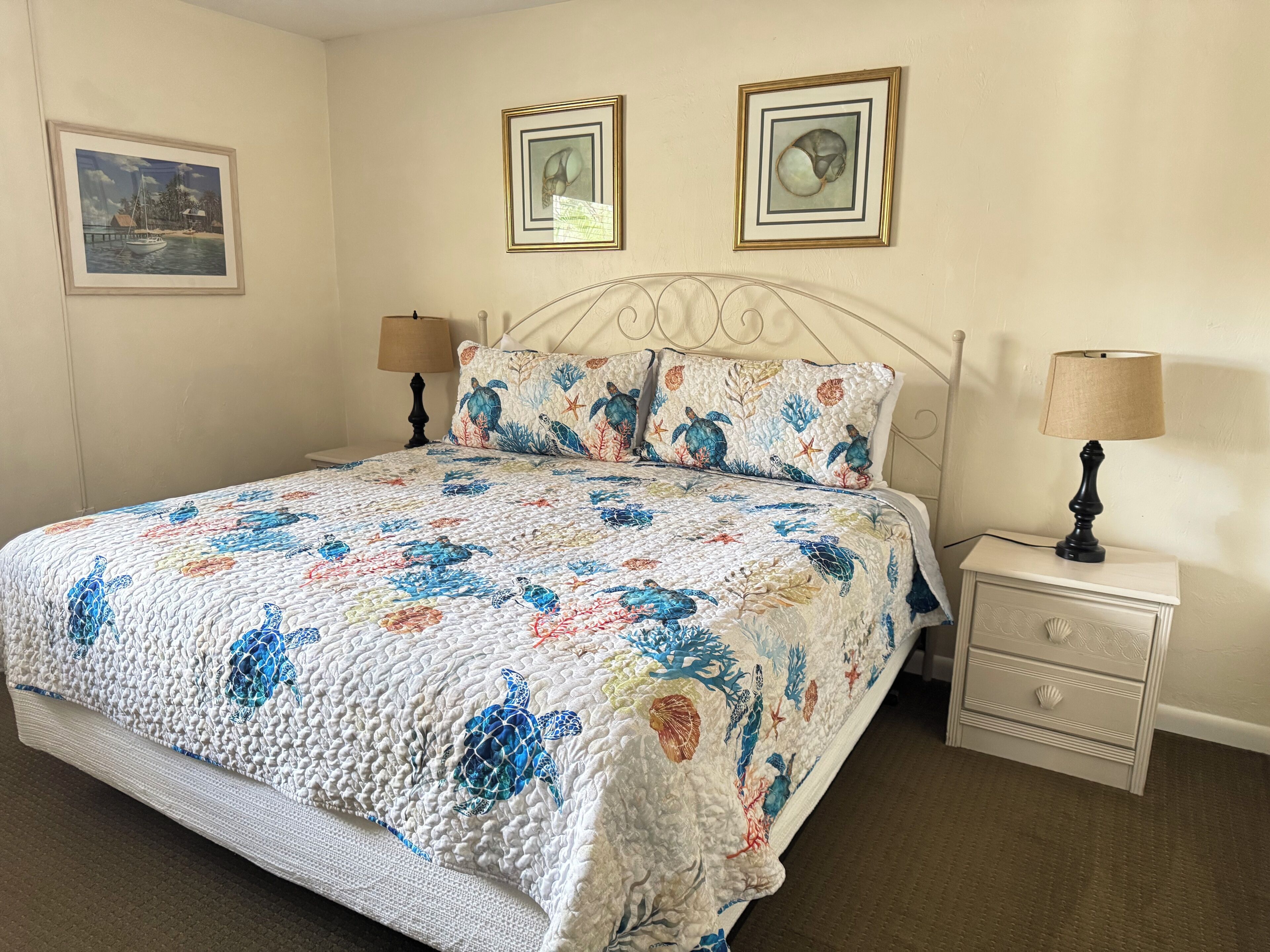 A bedroom with a bed, two bedside tables, and a nightstand.