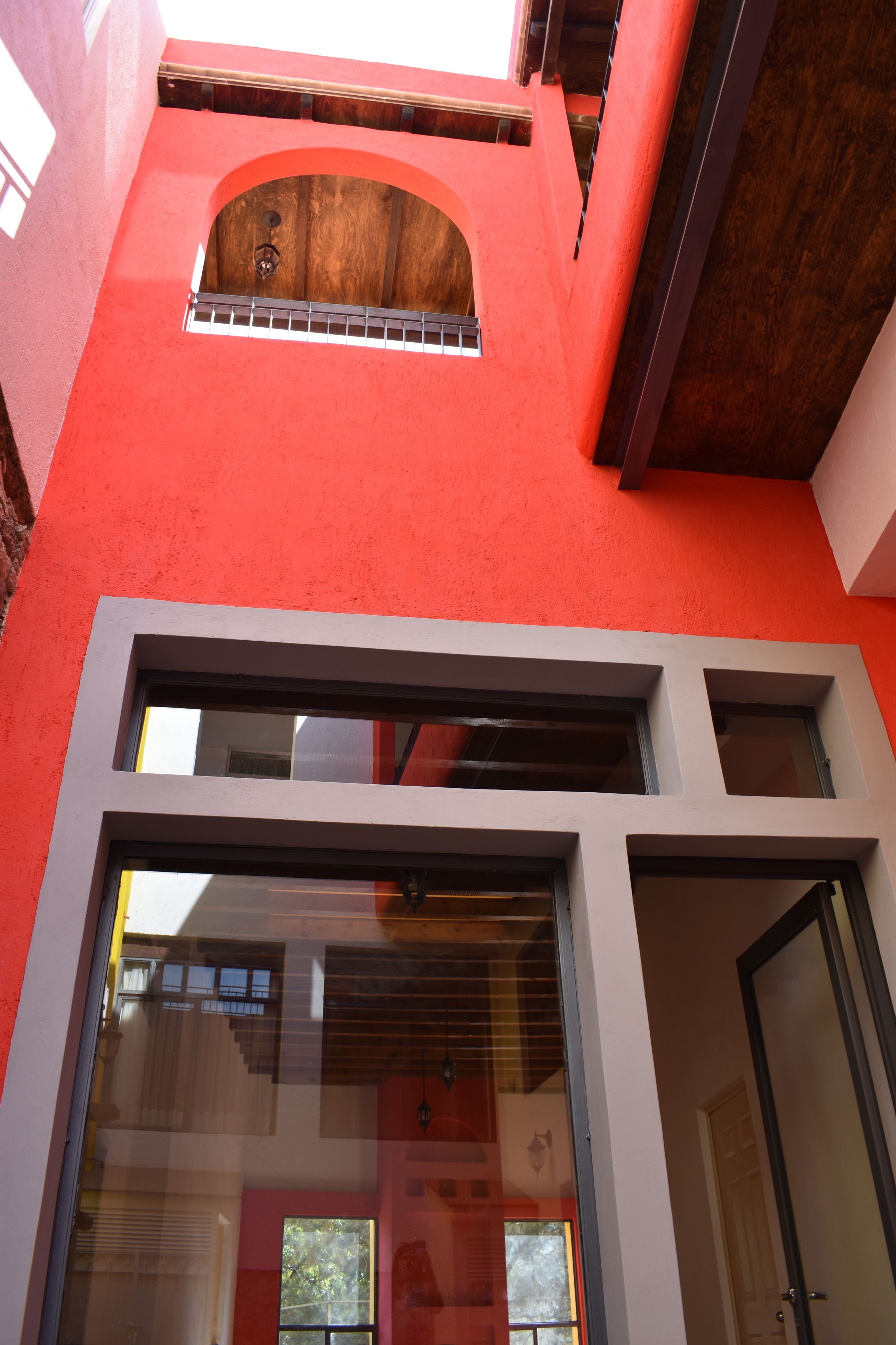 A red building with a large glass door and windows.