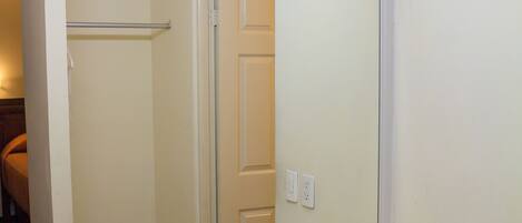 A bathroom with a white sink, a mirror, and a light above the mirror.