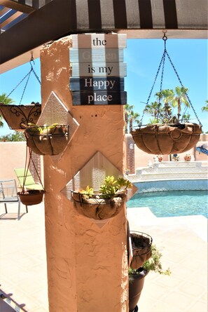 A pillar with hanging planters and a sign that reads "the Garden is my Happy place." - Sea Sand & Style ... (Cabo San Lucas)
