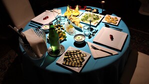 A round table set for a meal with various dishes, glasses, and cutlery. - CLASSIC ROOM IN VILLA SPA (Mesagne)