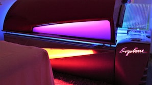 A tanning bed with a digital interface and a neon sign reading "Ergoline". - CLASSIC ROOM IN VILLA SPA (Mesagne)