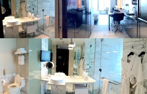Enjoy a luxurious bathroom experience with a large vanity, separate sink, toilet, bidet, and glass-enclosed shower.