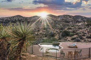 A desert landscape with a pool and lounge chairs, surrounded by cacti and mountains. - Morongo Star Ranch by Homestead Modern (Morongo Valley)