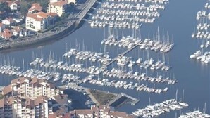 An aerial view of a marina with numerous boats docked, surrounded by residential buildings. - CAP SUD residence- Flat for 3 persons close to marina (CAPBRETON)