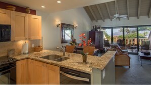 A modern kitchen with granite countertops, stainless steel appliances, and a large island. - Ocean-View Maui Kamaole Condo – A/C, Lanai, Walk to Beach & Pool! (Kihe)