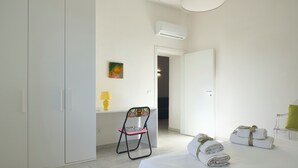 A hotel room with a bed, a chair, a desk, and a painting on the wall. - House of Arts apartments ♠ (Montelupo Fiorentino)
