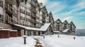 A multi-story hotel with a snow-covered exterior and a clear sky.