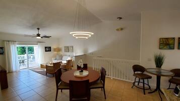 Enjoy meals in this stylish dining area with a high ceiling, dining table, and comfortable seating.