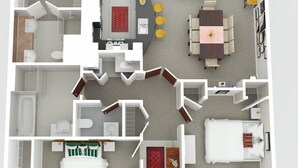 Un plan d’étage en 2D d’une chambre d’hôtel comprenant un lit, un bureau, un canapé, un coin repas et une salle de bain.