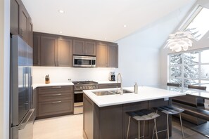 Prepare meals in the fully equipped kitchen with a gas stove, microwave, and refrigerator.
