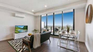 Deluxe Apartment, 2 Bedrooms | Living area | Flat-screen TV