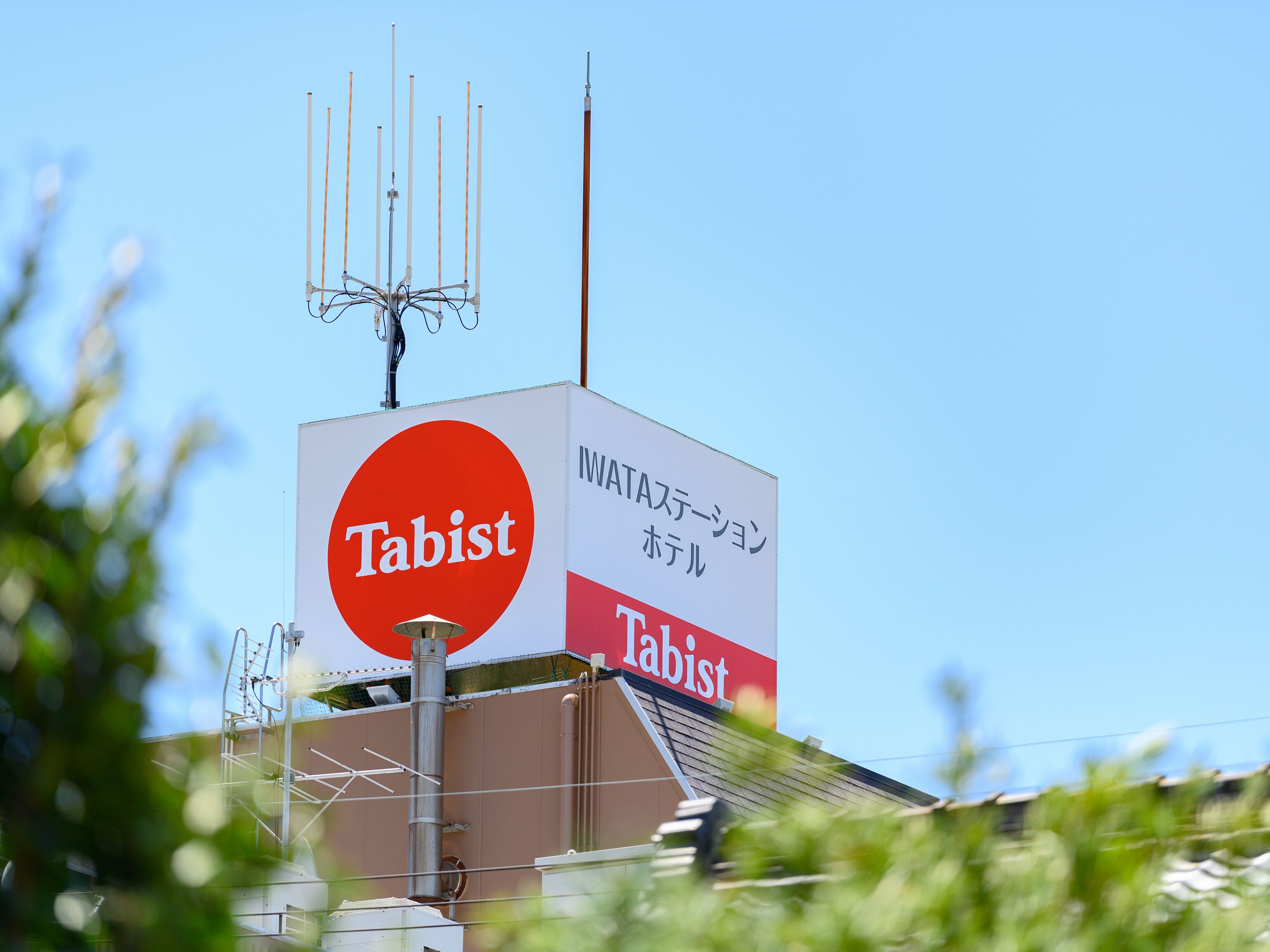 A building with a large sign reading 'Tabist' and Japanese text indicating it's a hotel.