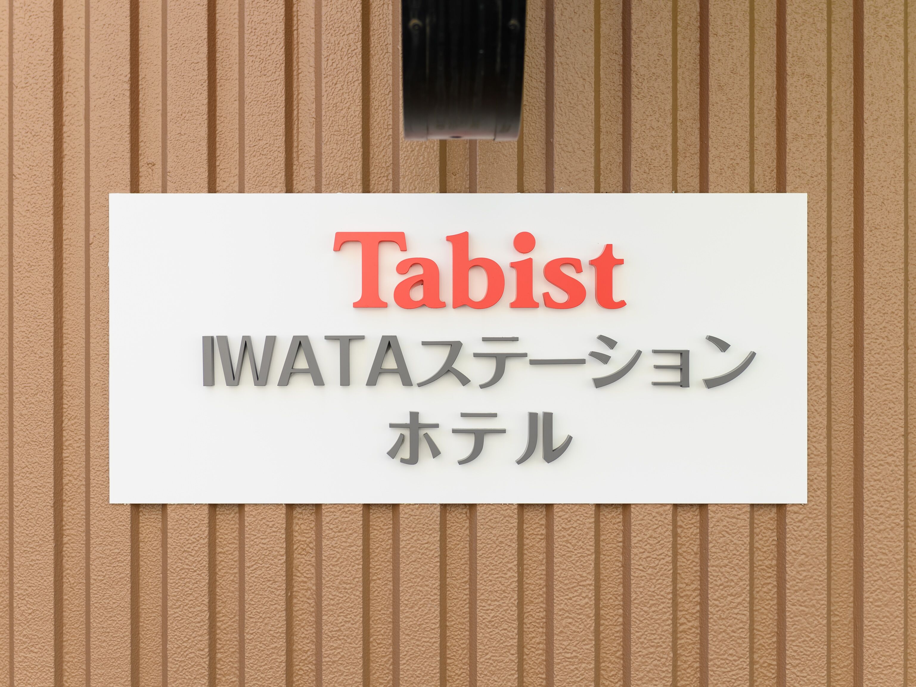 A sign with the word "Tabist" in red and Japanese text below it.