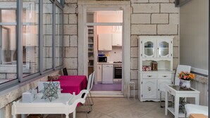 A compact kitchen with a microwave, stove, and cabinets.