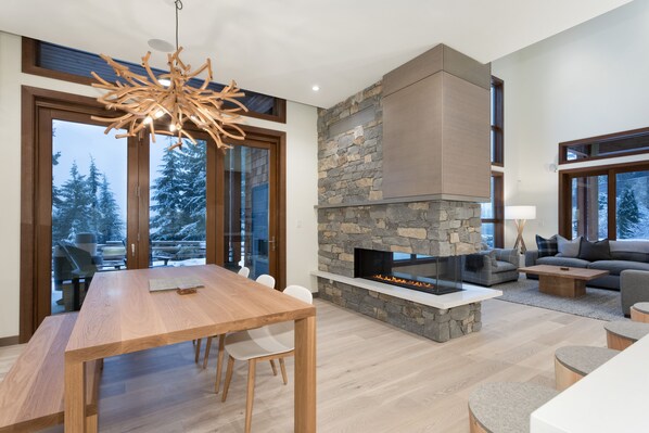 Relax in this inviting living room with a fireplace, comfortable seating area, and stunning views of the surrounding landscape.