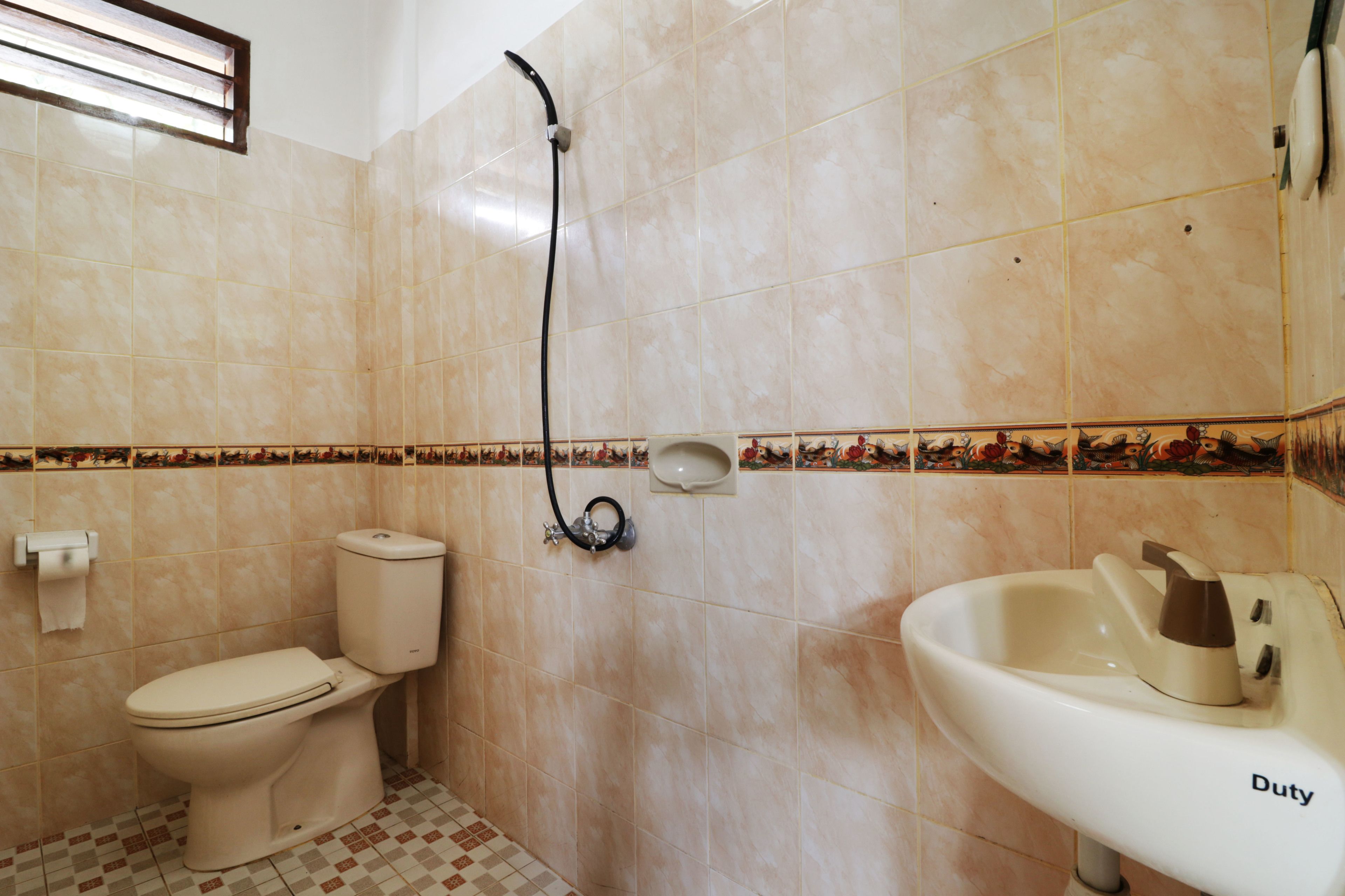 A bathroom with a toilet, a sink, and a shower.