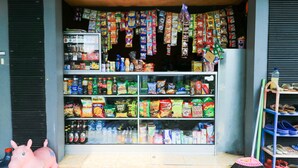 A store with shelves stocked with snacks, beverages, and other items. - Penginapan Villa Surya Alam (Prigen)