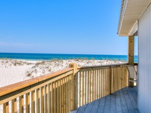 A wooden deck with a view of the beach and ocean. - Erica's Sandpiper. 8BR Beachfront. Heatable Pool. Single story! (Gulf Shores)