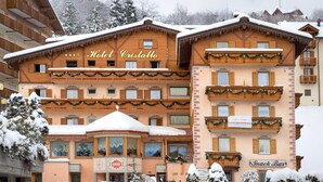 A hotel named "Hotel Cristallo" with multiple floors, balconies, and a "Snack Bar" sign. - Hotel Cristallo (Andalo)