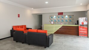 A reception area with a counter, a fire extinguisher, and a RedDoorz sign. - RedDoorz Plus near Banyuwangi Airport (Rogojampi)