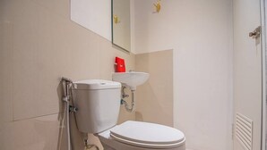 Een badkamer met toilet, wastafel en douche.