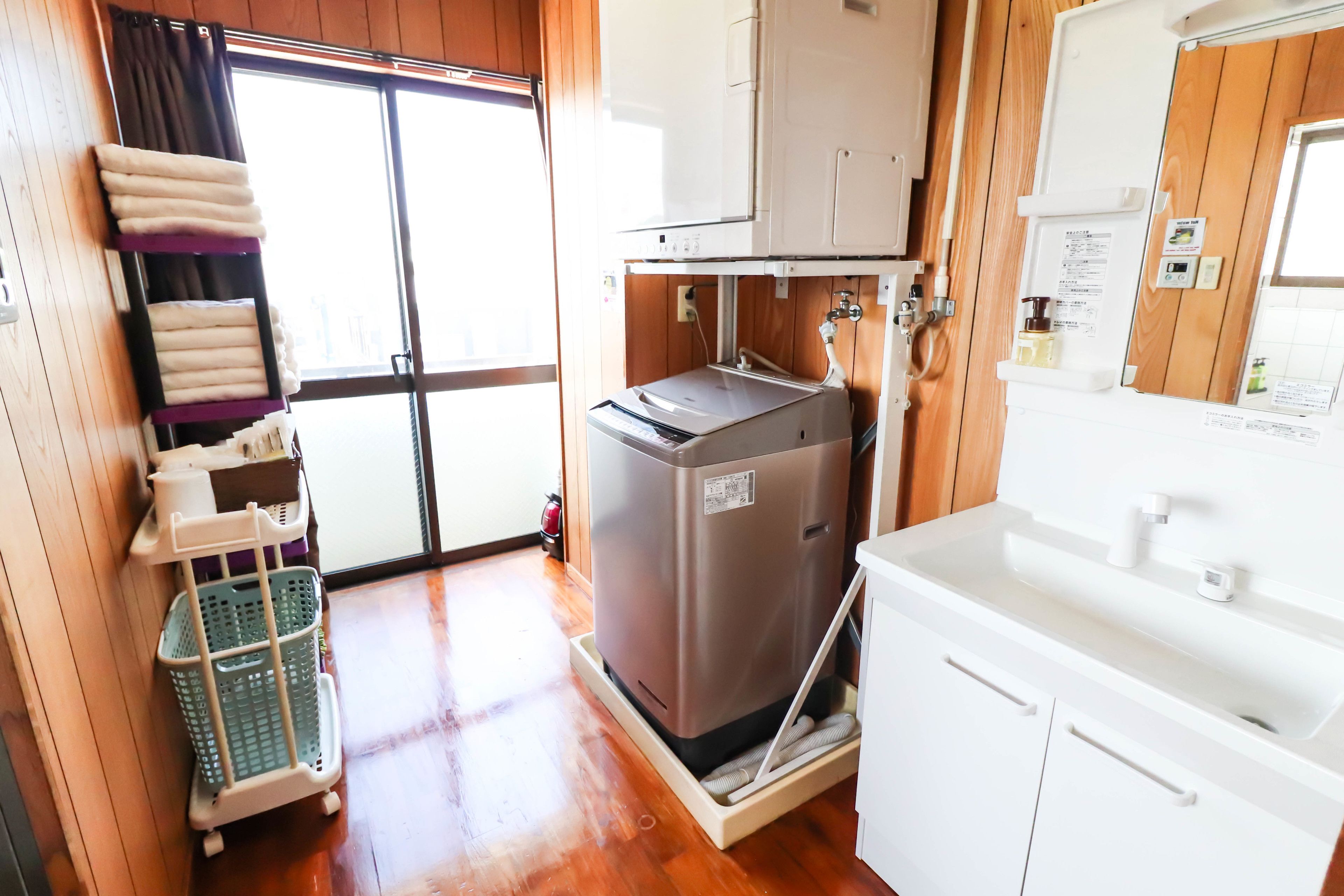 A compact kitchen with a refrigerator, sink, and storage cabinets.