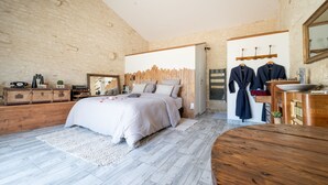 A bedroom with a bed, wooden dresser, and a vanity with a mirror. - L'Echappee Vendeenne Chambres d'Hotes (Saint-Aubin-la-Plaine)