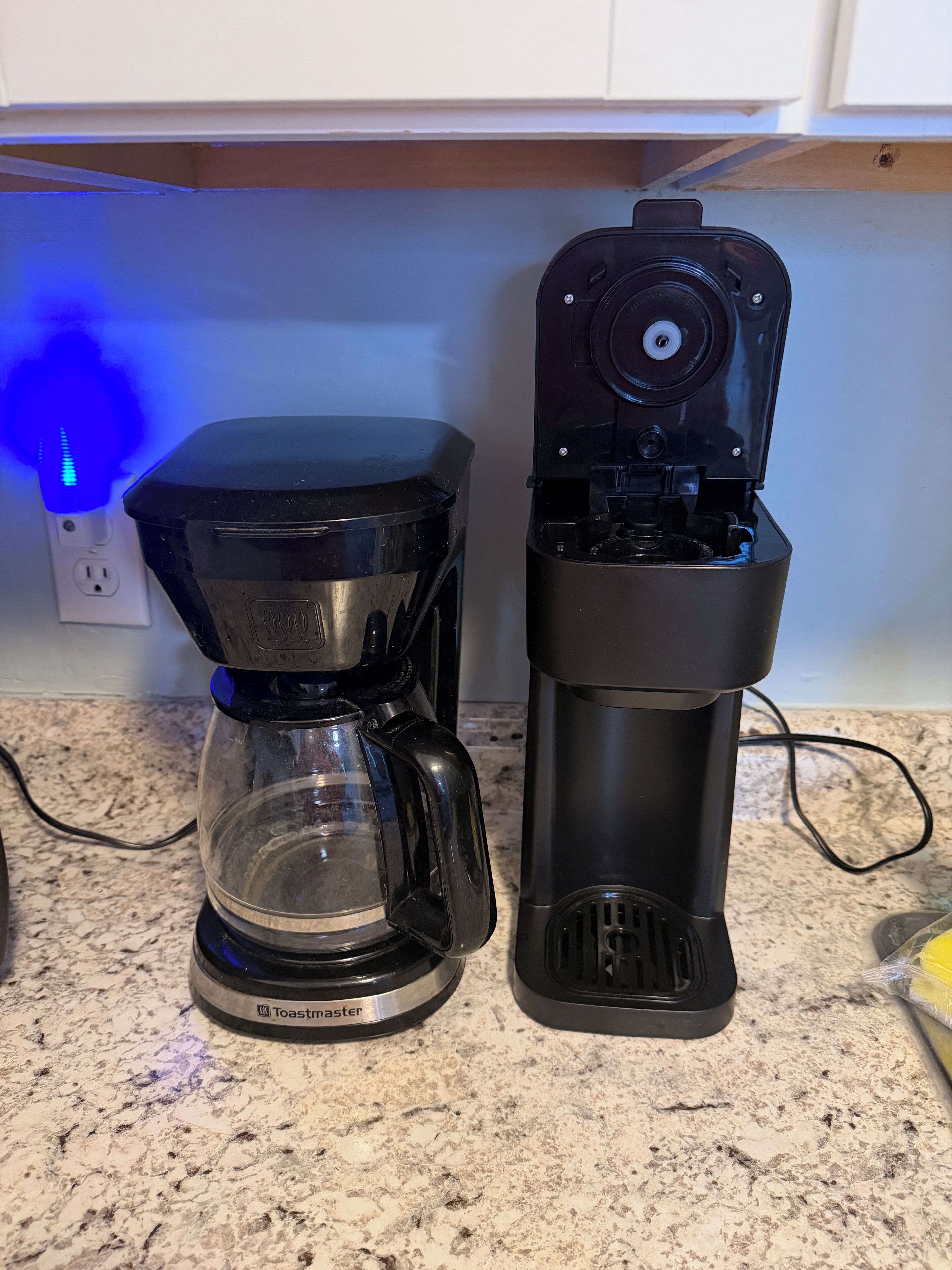 A coffee maker and a water dispenser on a kitchen counter.