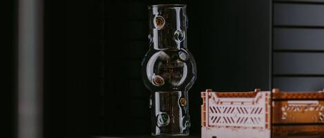 A shelf with a metallic object and a crate.