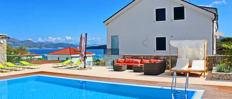 Outdoor pool, a heated pool, pool loungers