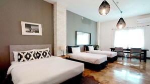 Une chambre d’hôtel avec deux lits, un bureau et une chaise.