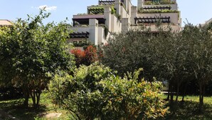 A modern building with multiple balconies and green plants. - Apartment Alma - Two Bedroom Apartment with Terrace and Sea View (Dubrovnik)