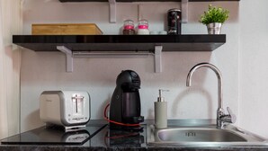 A modern kitchen with a coffee maker, toaster, and sink. - Apartments Ivana Old Town - Standard Studio - APT3 (Dubrovnik)