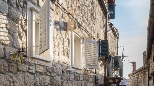 A narrow stone street with buildings on either side, a visible door, and a small step leading down. - Apartments Ivana Old Town - Standard Studio - APT3 (Dubrovnik)