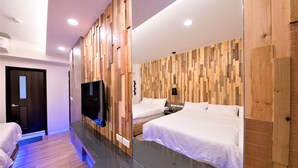 A modern hotel room with a wooden accent wall, a flat-screen TV, two beds, a bedside table, and a nightstand. - Clear Sky Laurel B&B (Magong)