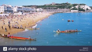 A beach with boats and people. - Dover Adventure Backpackers (Dover)