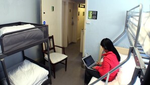 A bunk bed room with a laptop on the lower bunk. - Dover Adventure Backpackers (Dover)