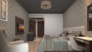 A modern bedroom with a large bed, a desk, and a chair. There is a TV on the wall and a door leading to another room. - Enrise by Sayaji Rau (Indore)