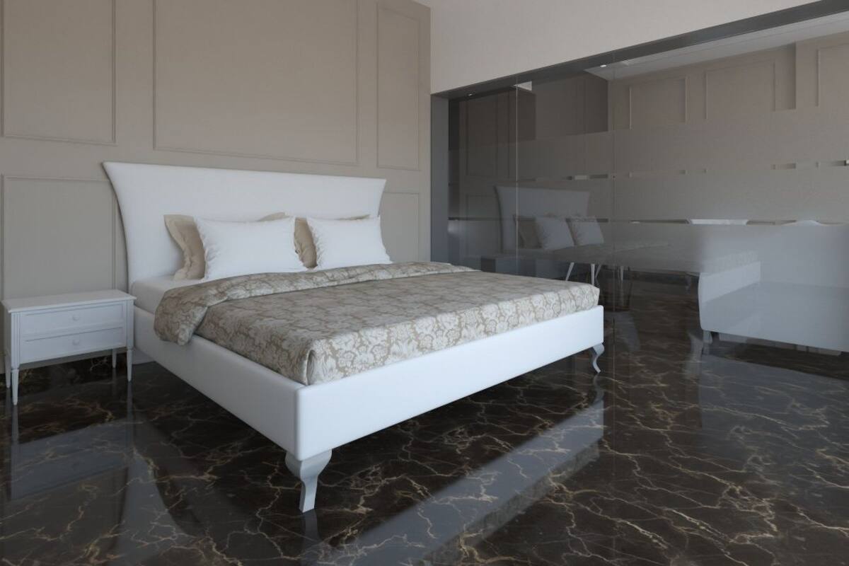 A modern bedroom with a large bed, a nightstand, a glass-enclosed bathroom, and a seating area with a white sofa.