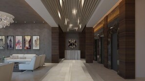 A modern lobby with a central reception desk, a white sofa area, and a patterned ceiling. - Enrise by Sayaji Rau (Indore)