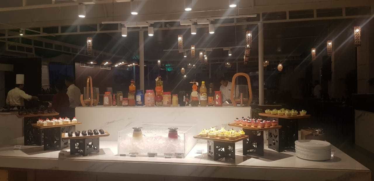 A buffet setup with various food items and condiments.