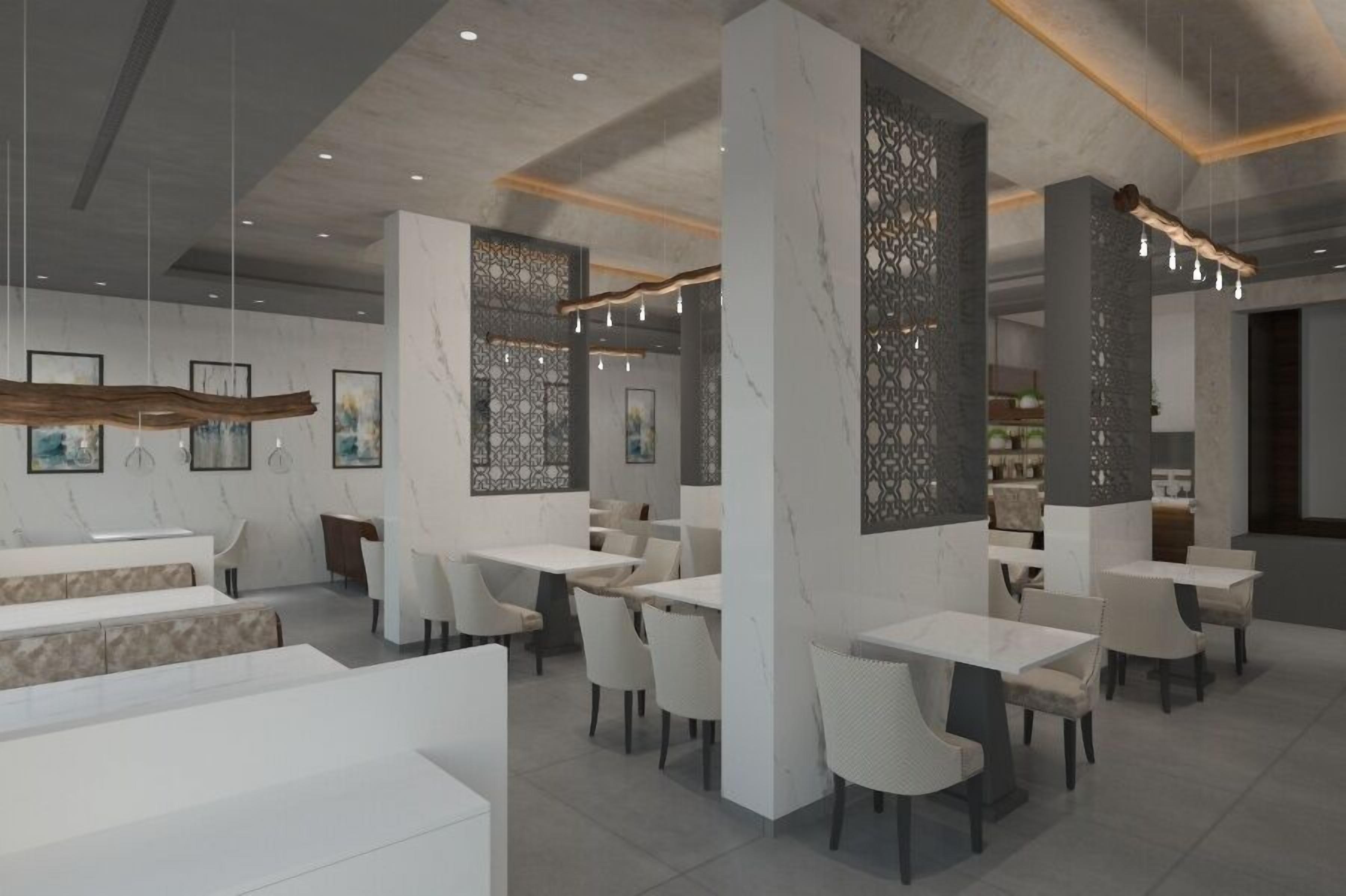 A modern restaurant interior with white marble walls, wooden accents, and contemporary furniture.