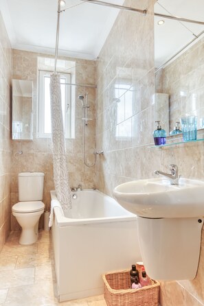 Departamento Deluxe, varias camas | Baño | Tina con regadera, secadora de cabello, toallas 
