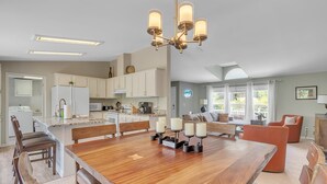 A spacious kitchen with a large island, modern appliances, and a chandelier. - Experience breathtaking views at Sedona Thunder Mountain Cottage, a spacious 3-bedroom retreat. (Sedona)