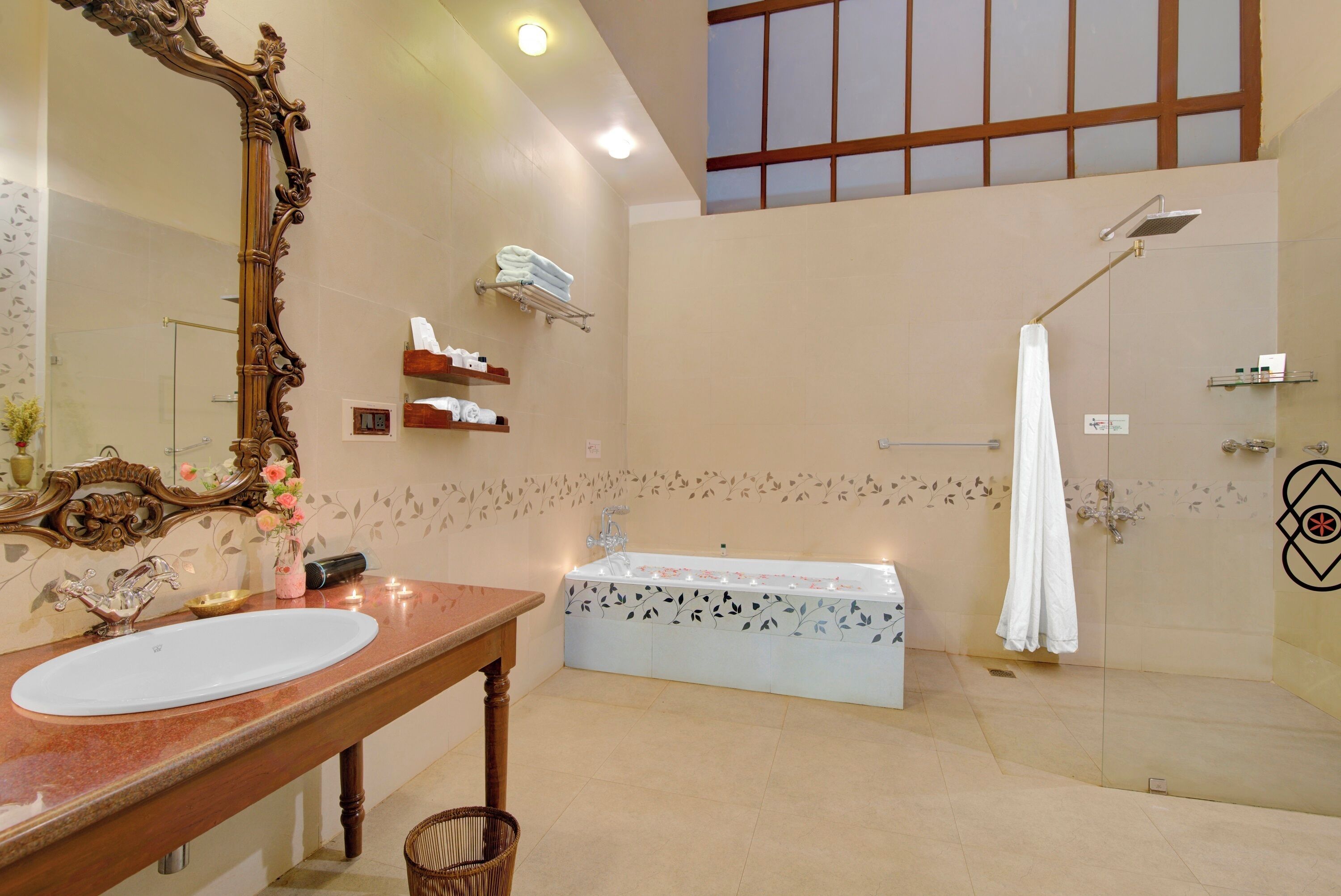 A spacious bathroom with a large mirror, a bathtub, and a shower.