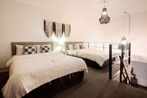 A hotel room with two beds, a hanging macrame wall decoration, and a staircase with a railing. - Two Level Suite Apt for 4 adults (Jongno 1(il).2(i).3(sam).4(sa))